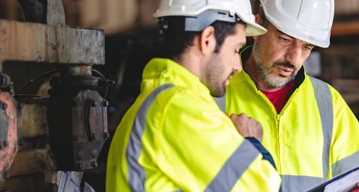 Hantover lock out tag out professional technician engineering workers with safety hard hats maintaining construction equipment in industrial setting